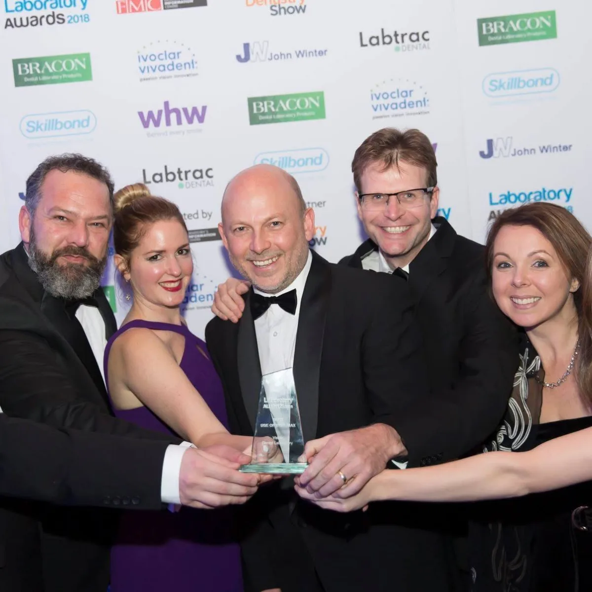 The Vision Dental Laboratory team holding their award at the Laboratory Awards 2018